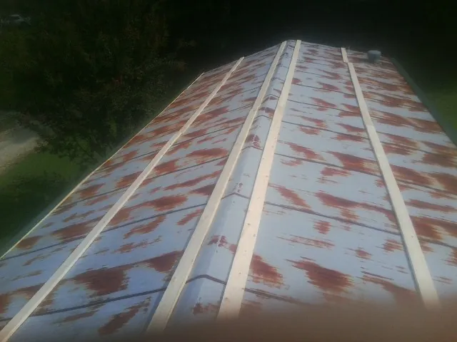Rusted metal roof panels with new wood purlins before replacement — Storm Damage Roof Repair in New Britain by Roofing Brothers