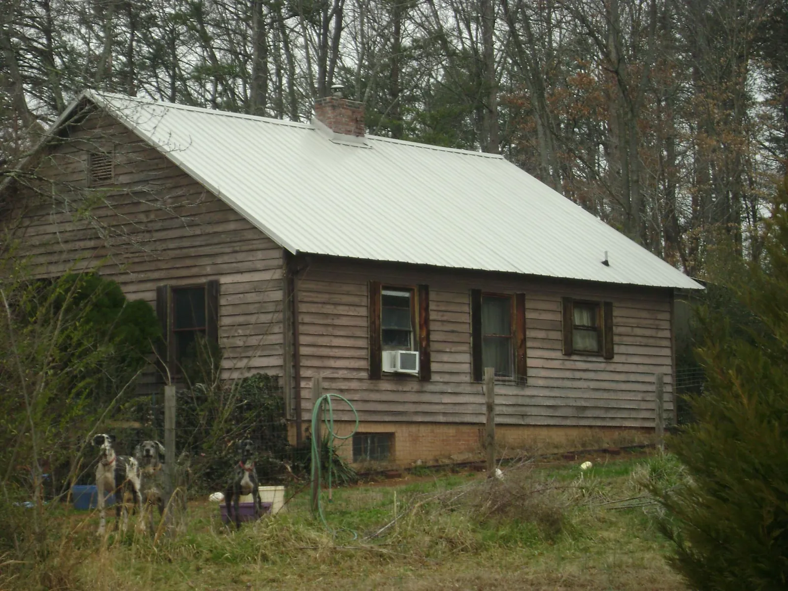 White metal roof on an old wood sided farmhouse, from a Metal Roof Installation job in New Britain
